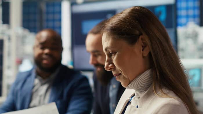 Woman participating in a business meeting, representing how ordinary professionals can rationalize unethical decisions in white-collar crime cases.